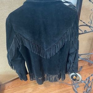 Genuine leather and suede fringe jacket .